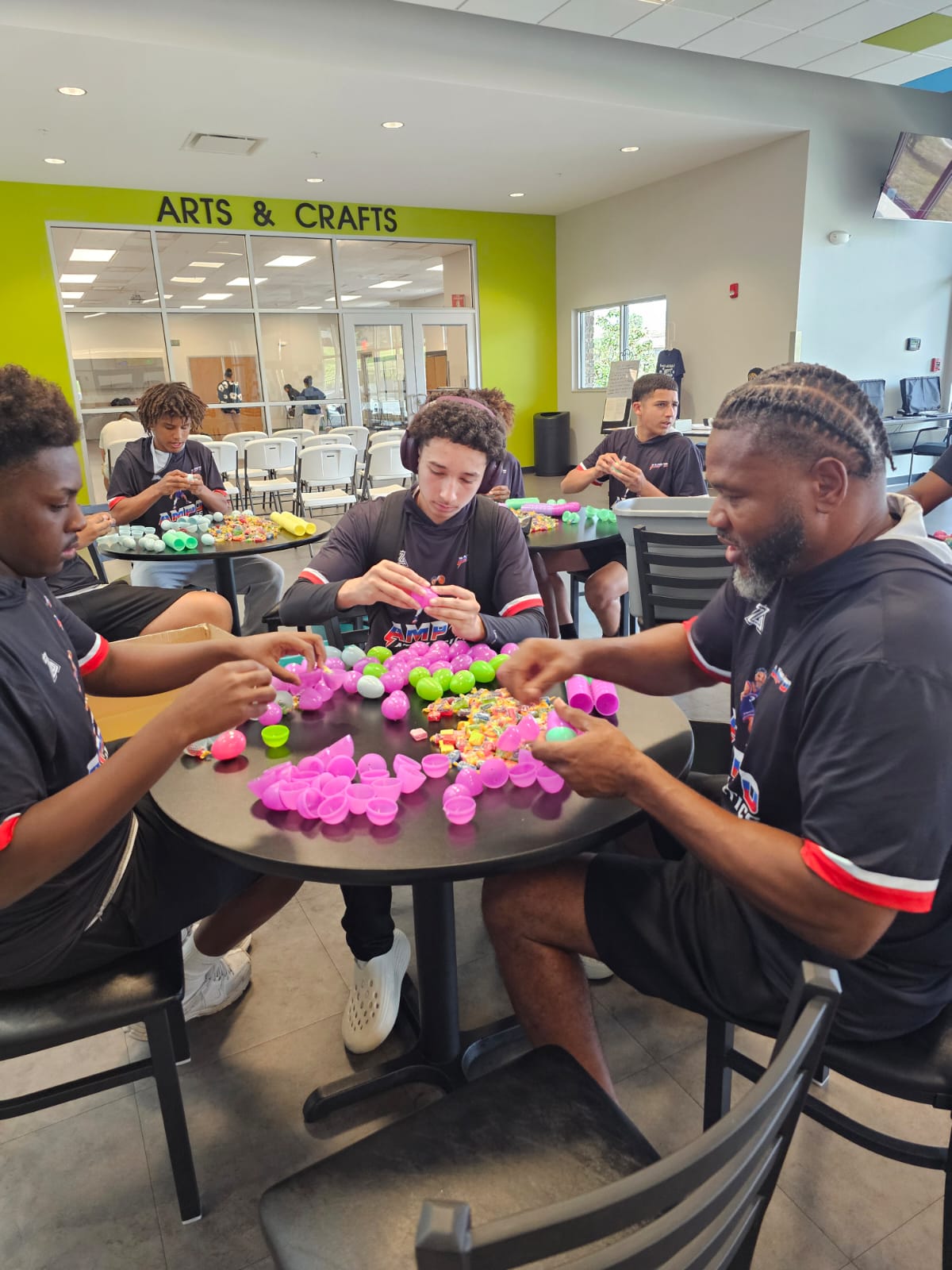 AMPD players and coach sorting Easter eggs at the Tom Fellows Community Center