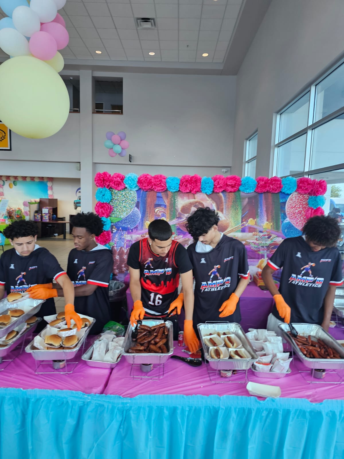 AMPD players serving hamburgers and hot dogs at the Jarrett Gordon Ford Easter fundraiser
